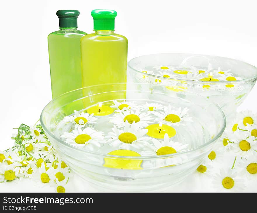 Spa bowl with water with daisy flowers and shampoo. Spa bowl with water with daisy flowers and shampoo