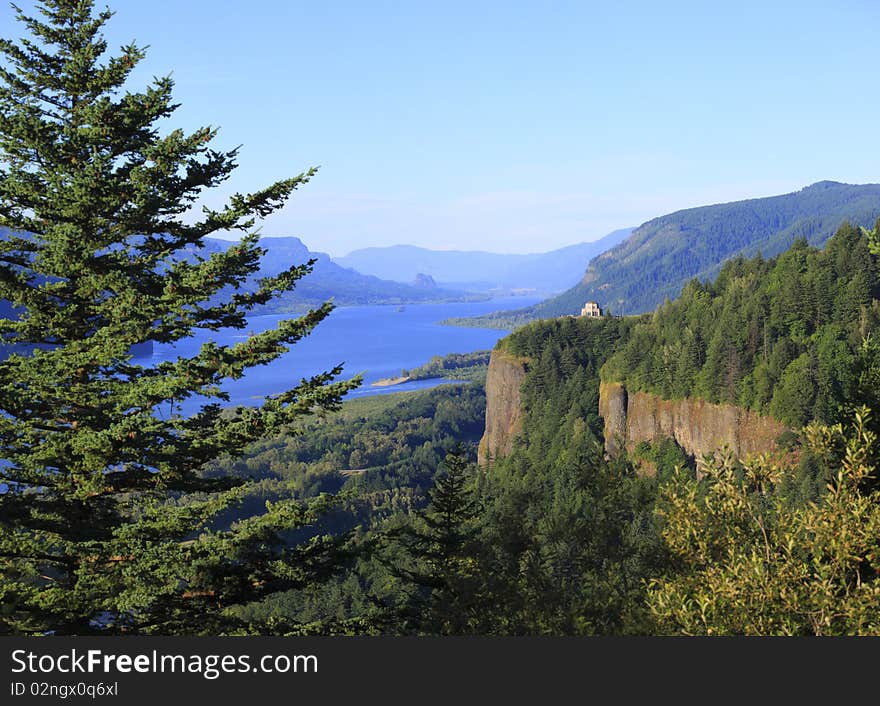 A view of the Columbia river gorge valley and vista house in the distance. A view of the Columbia river gorge valley and vista house in the distance.