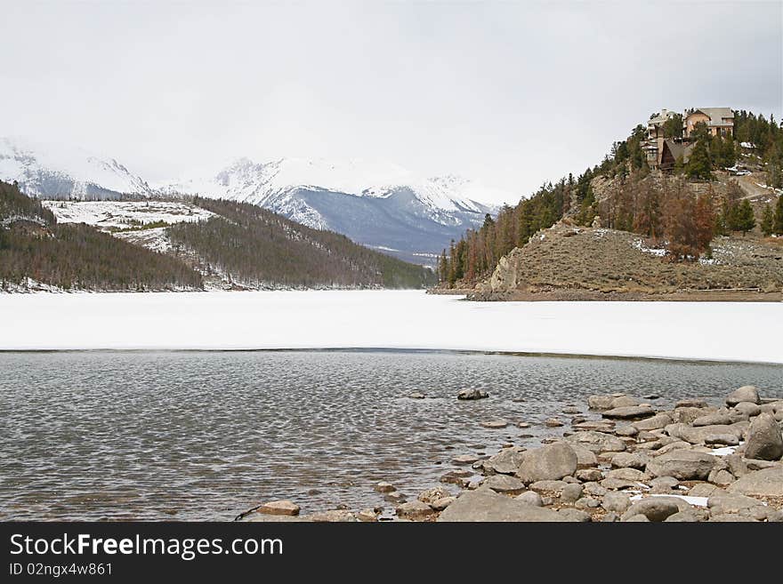 Houses are perched on a ridge overlooking Lake Dillion in the Rocky Mountains. Taken in late winter as the ice is going out. Houses are perched on a ridge overlooking Lake Dillion in the Rocky Mountains. Taken in late winter as the ice is going out.