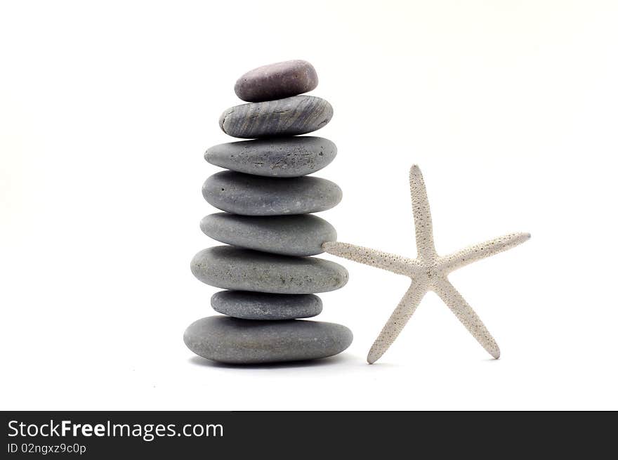 Stack stones with starfish on white