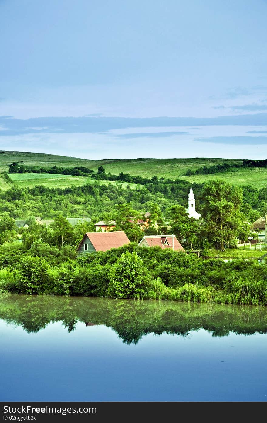 A village on the lake with coast reflection. A village on the lake with coast reflection