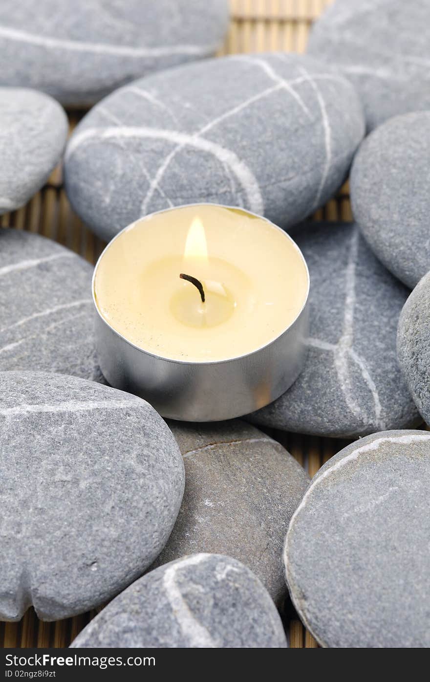 A light candle with pebble. A light candle with pebble