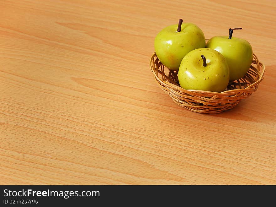 A basket with three green apples. A basket with three green apples