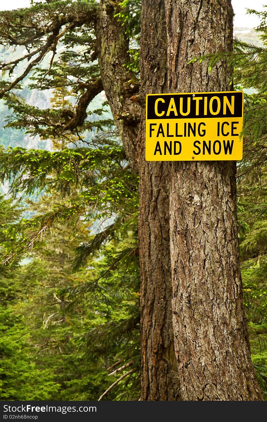 A sign warning hikers of the dangerous potential for falling ice and snow. A sign warning hikers of the dangerous potential for falling ice and snow