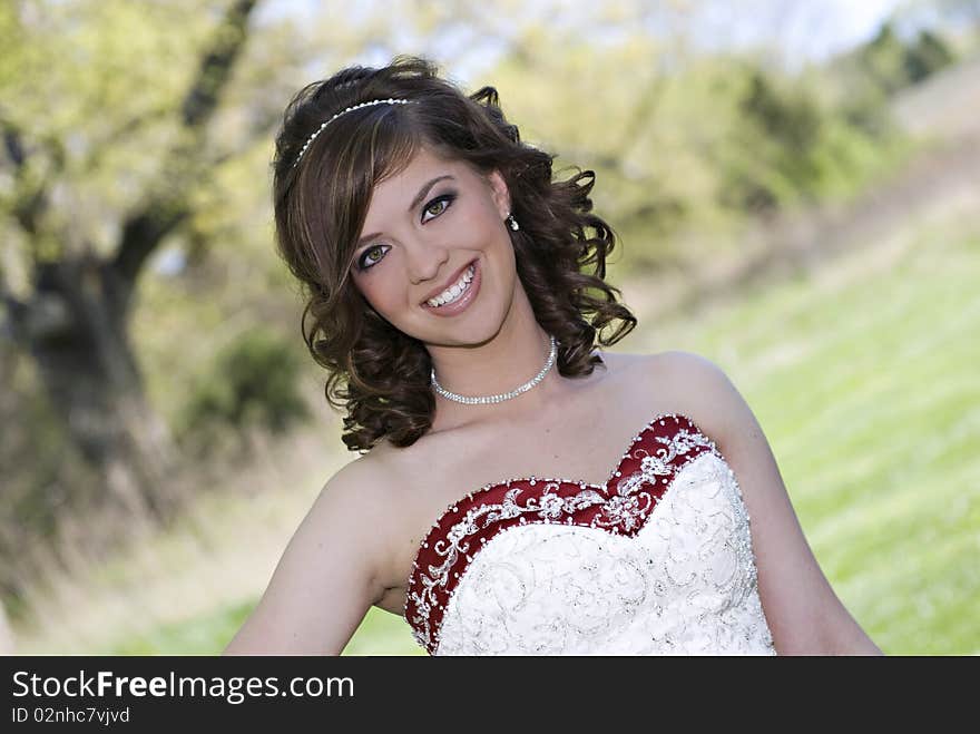 A beautiful smiling bride with selective focus and scenic background