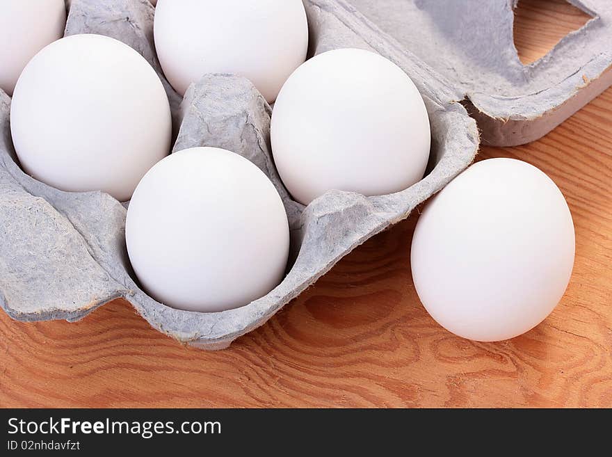 Eggs of white colour are combined in a special tray for transportation and sale.