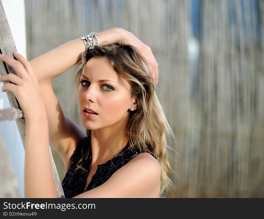 Young pretty fashion woman outdoors in sunny summer day