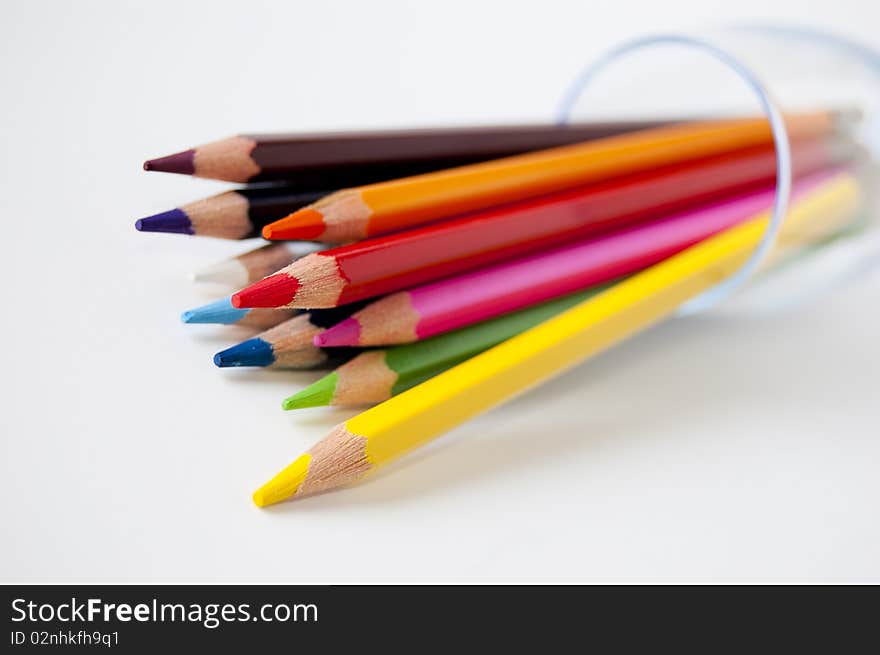 Close up of many colored pencils in a glass