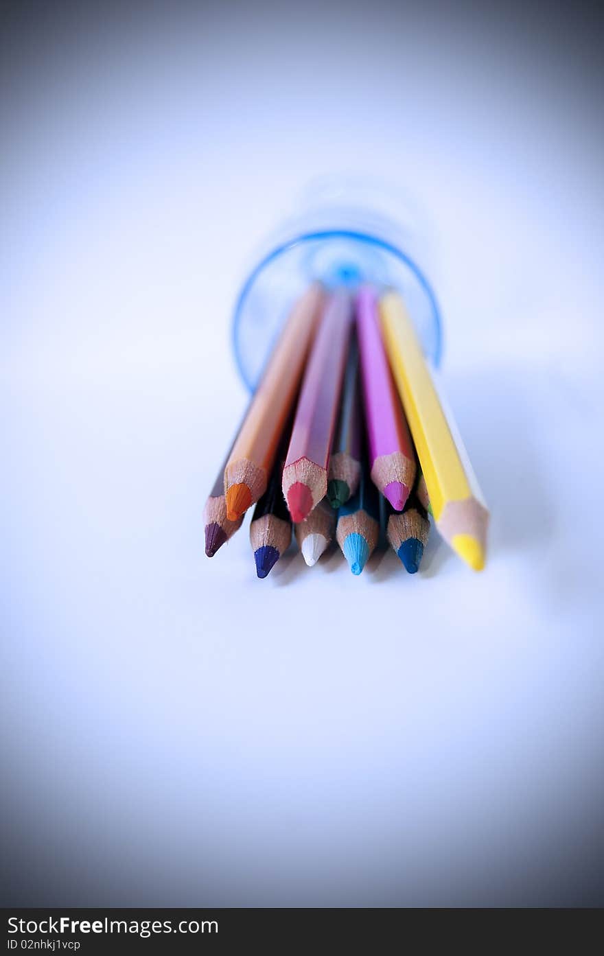 Close up of many colored pencils in a glass