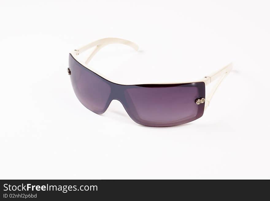 Elegant  sunglasses in a white frame on a light background