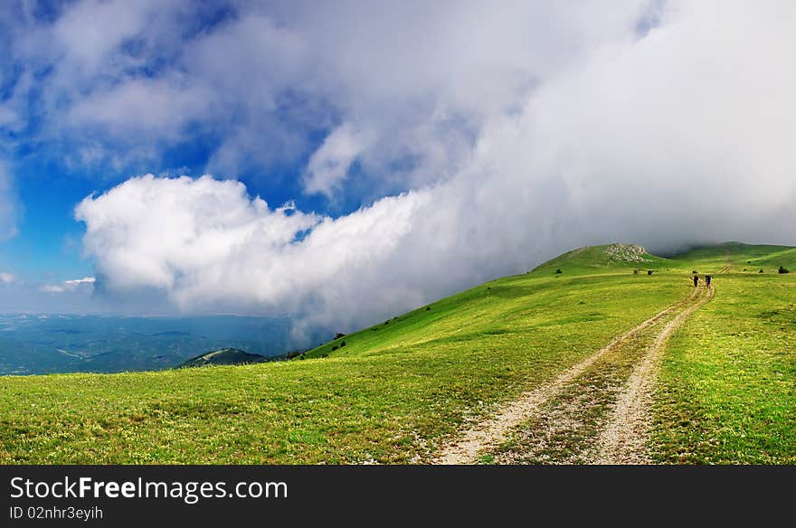 Hill with road and big cloud