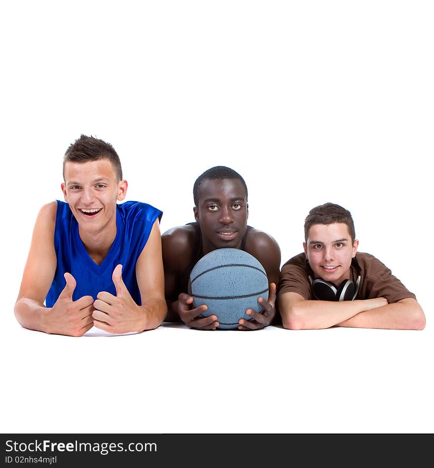 Young interracial group of happy sporty teenagers lying on the floor. Isolate over white. Young interracial group of happy sporty teenagers lying on the floor. Isolate over white.