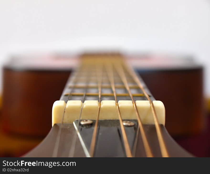 Acoustic guitar photographed from the neck. Acoustic guitar photographed from the neck