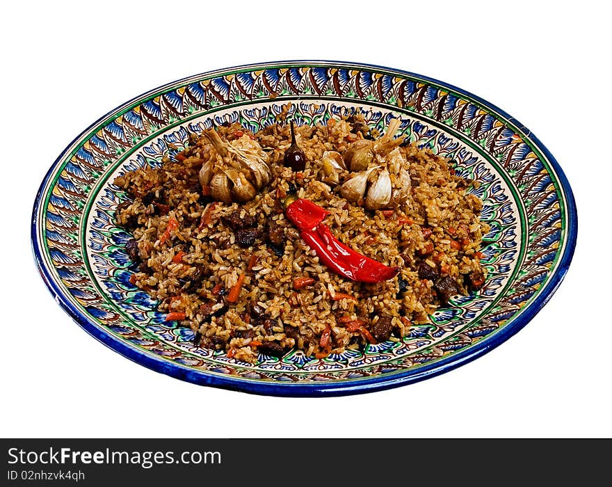 Central Asian plov on a dish with national painting