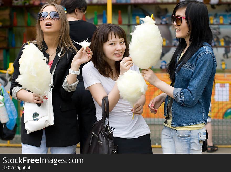 Three girls eating candy floss