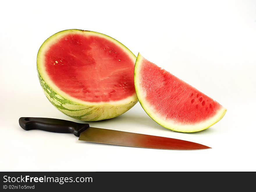 Pieces of watermelon with the knife on the white background. Pieces of watermelon with the knife on the white background