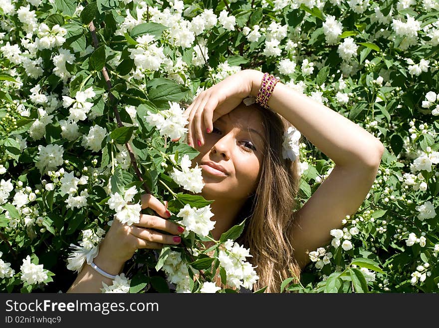 Girl standing near lilac