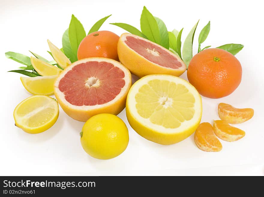 Group of fresh different citrus fruits with green leaves isolated on white with clipping path