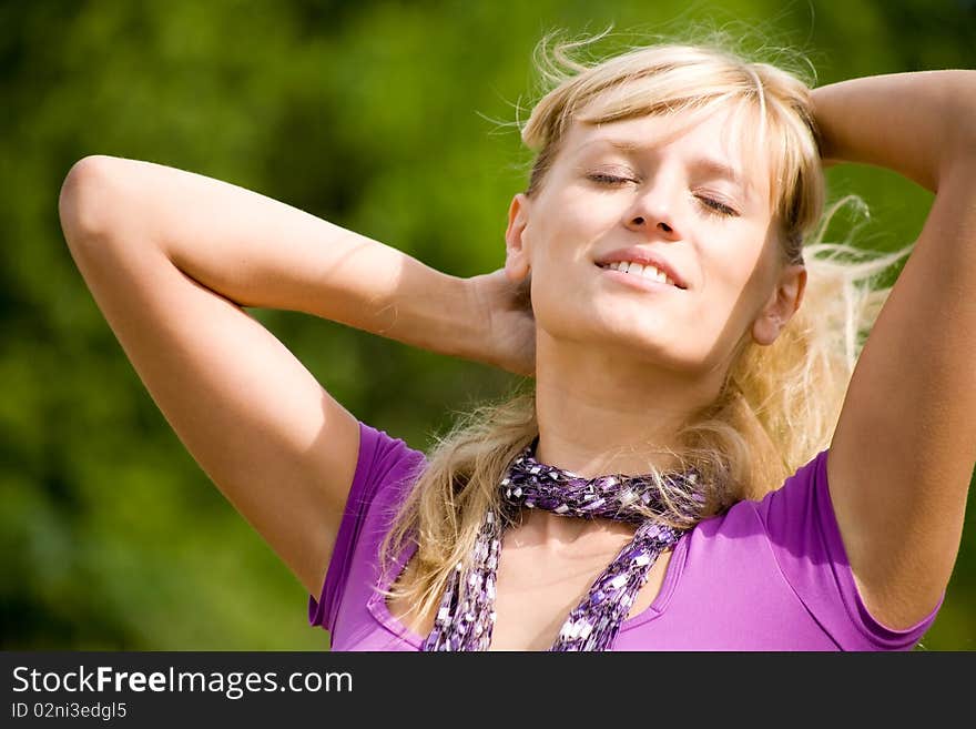 Young beautiful woman with fair hair  enjoy on  background  of green forest. Young beautiful woman with fair hair  enjoy on  background  of green forest