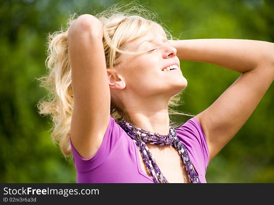 Young beautiful woman with fair hair  enjoy on  background  of green forest. Young beautiful woman with fair hair  enjoy on  background  of green forest