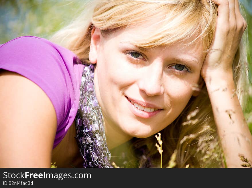 Young beautiful woman with fair hair lying and  enjoy on the meadow. Young beautiful woman with fair hair lying and  enjoy on the meadow