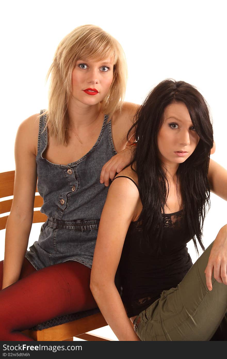 Two attractive teenage girls posing together for portraits. Two attractive teenage girls posing together for portraits