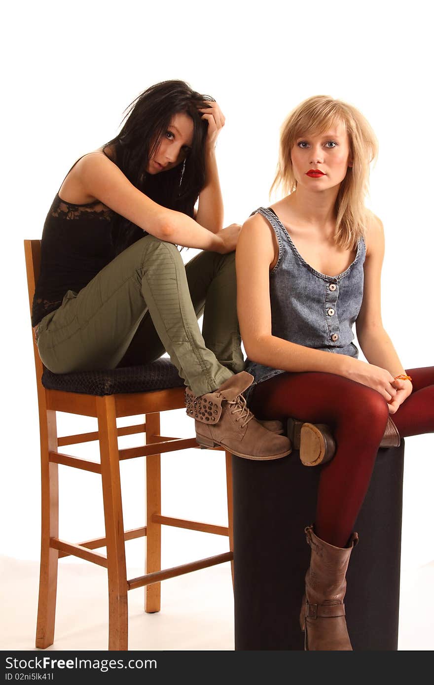 Two attractive teenage girls posing together for portraits. Two attractive teenage girls posing together for portraits