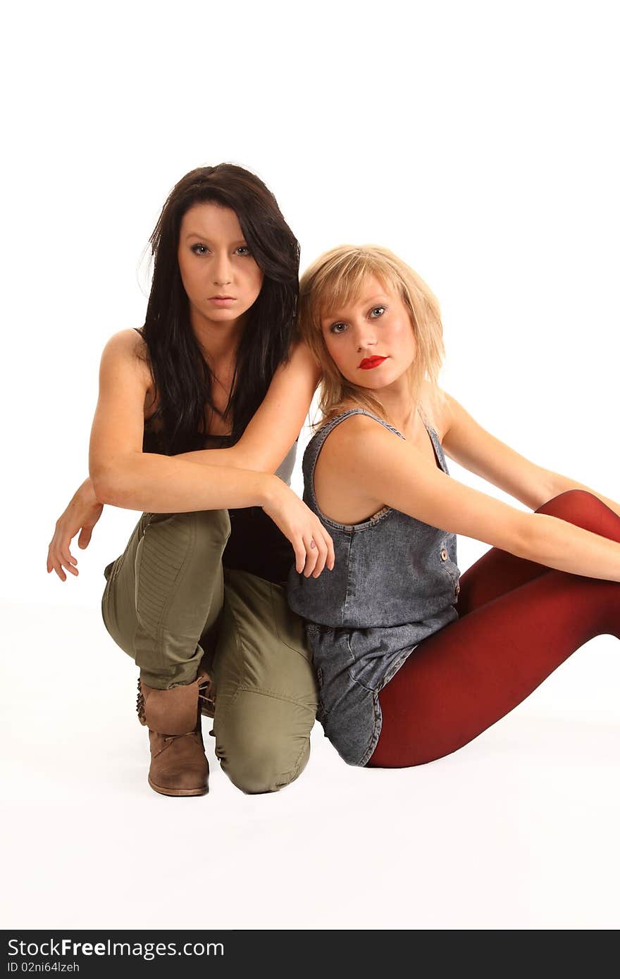 Two attractive teenage girls posing together for portraits. Two attractive teenage girls posing together for portraits