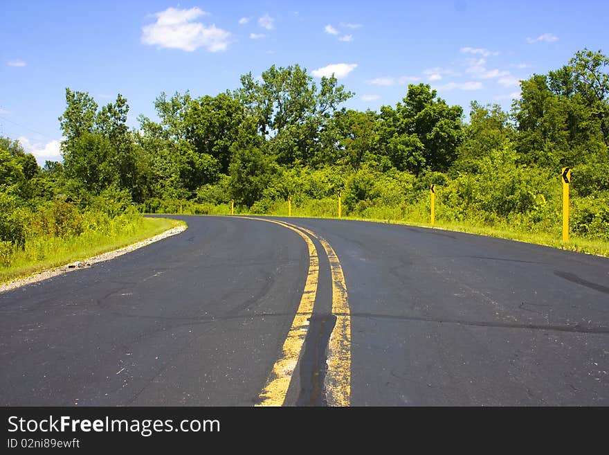 A turn in a black asphalt Road. A turn in a black asphalt Road