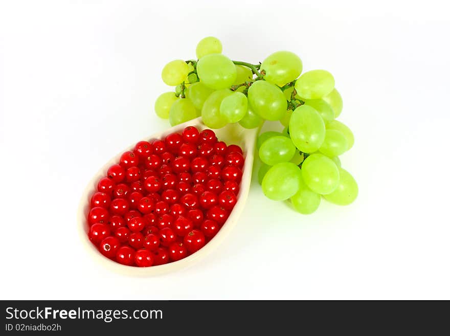 Grape and red currant isolated on white