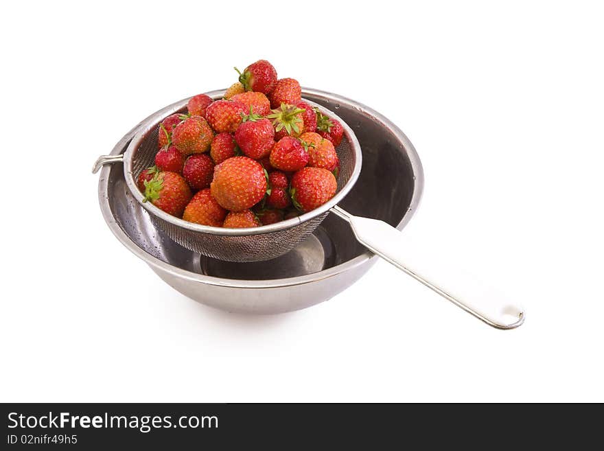 Fresh tasty strawberries in a colander isolated on white