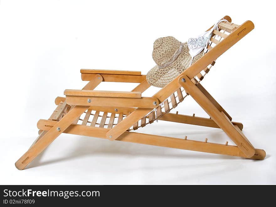 Beach chair, hat and a bikini top on a white background. Beach chair, hat and a bikini top on a white background.