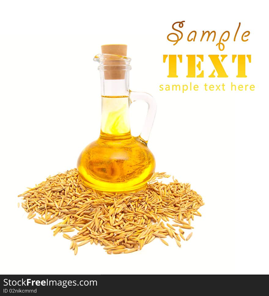 Small bottle with vegetable oil and wheat grains