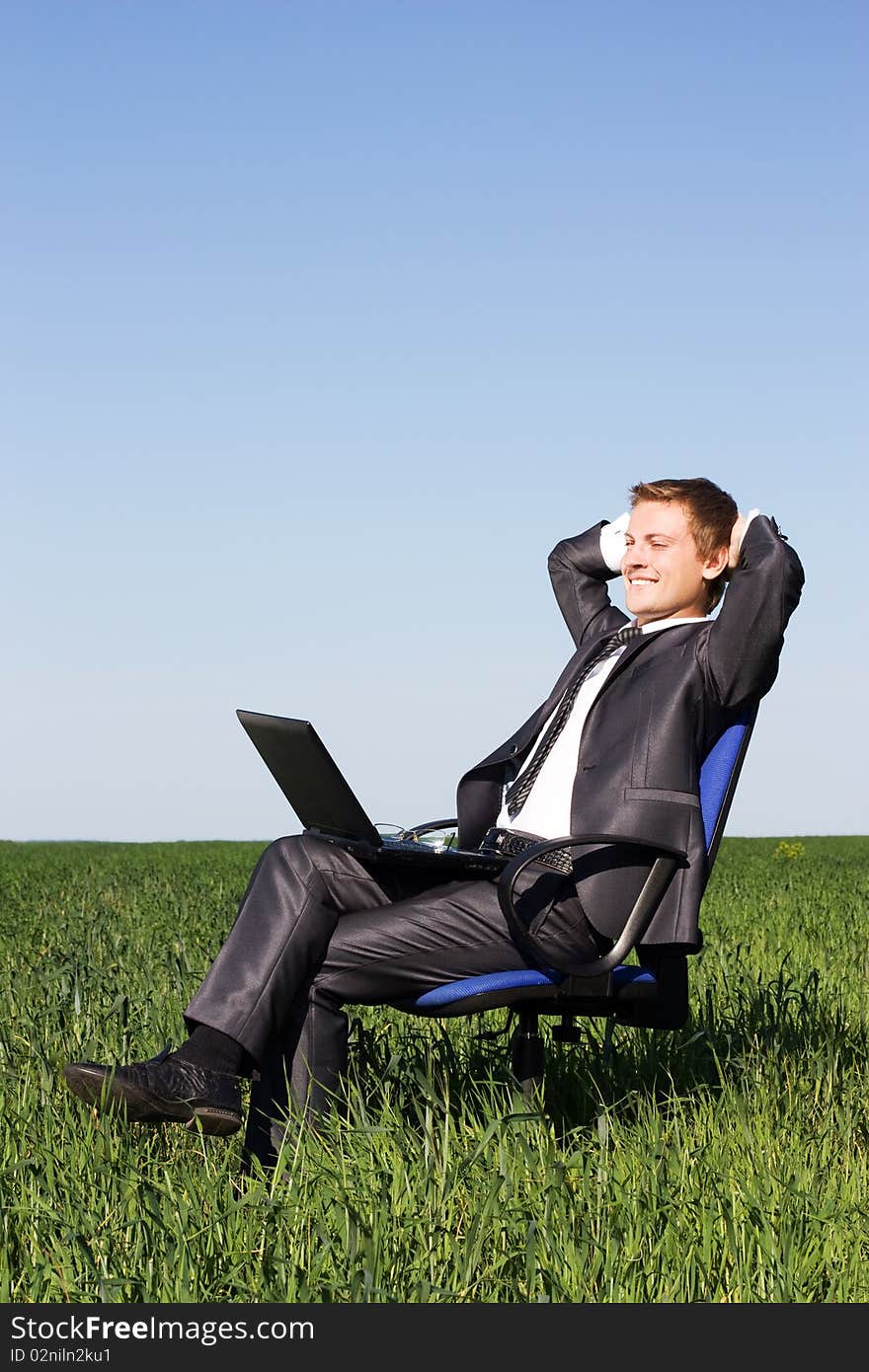 Businessman in the field, with a laptop. Happy, successful. Businessman in the field, with a laptop. Happy, successful