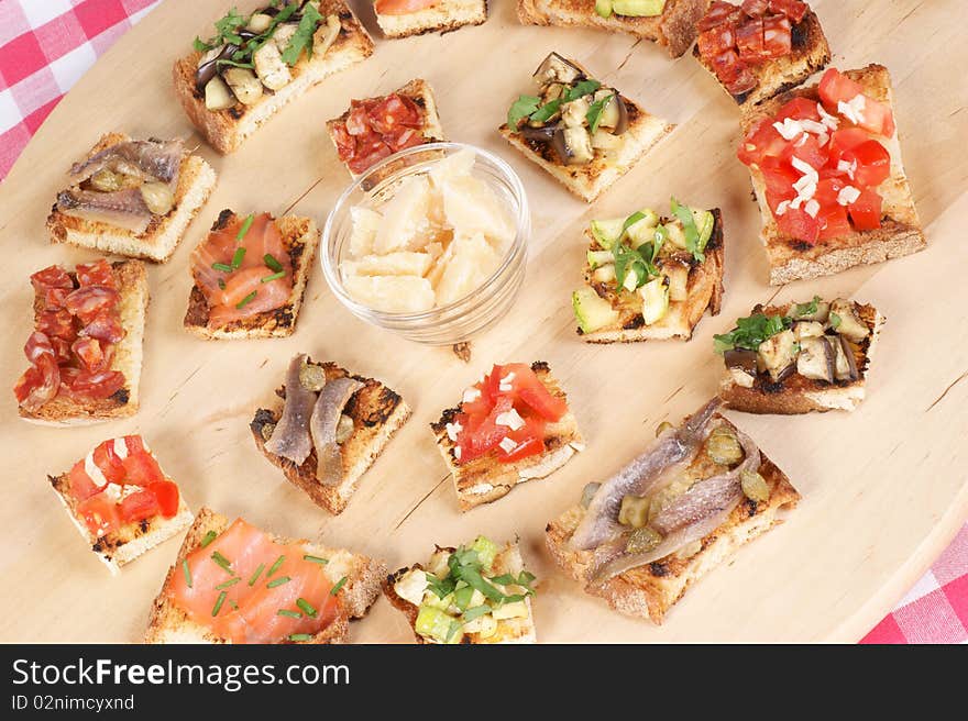 Various italian bruschetta over a cutting board