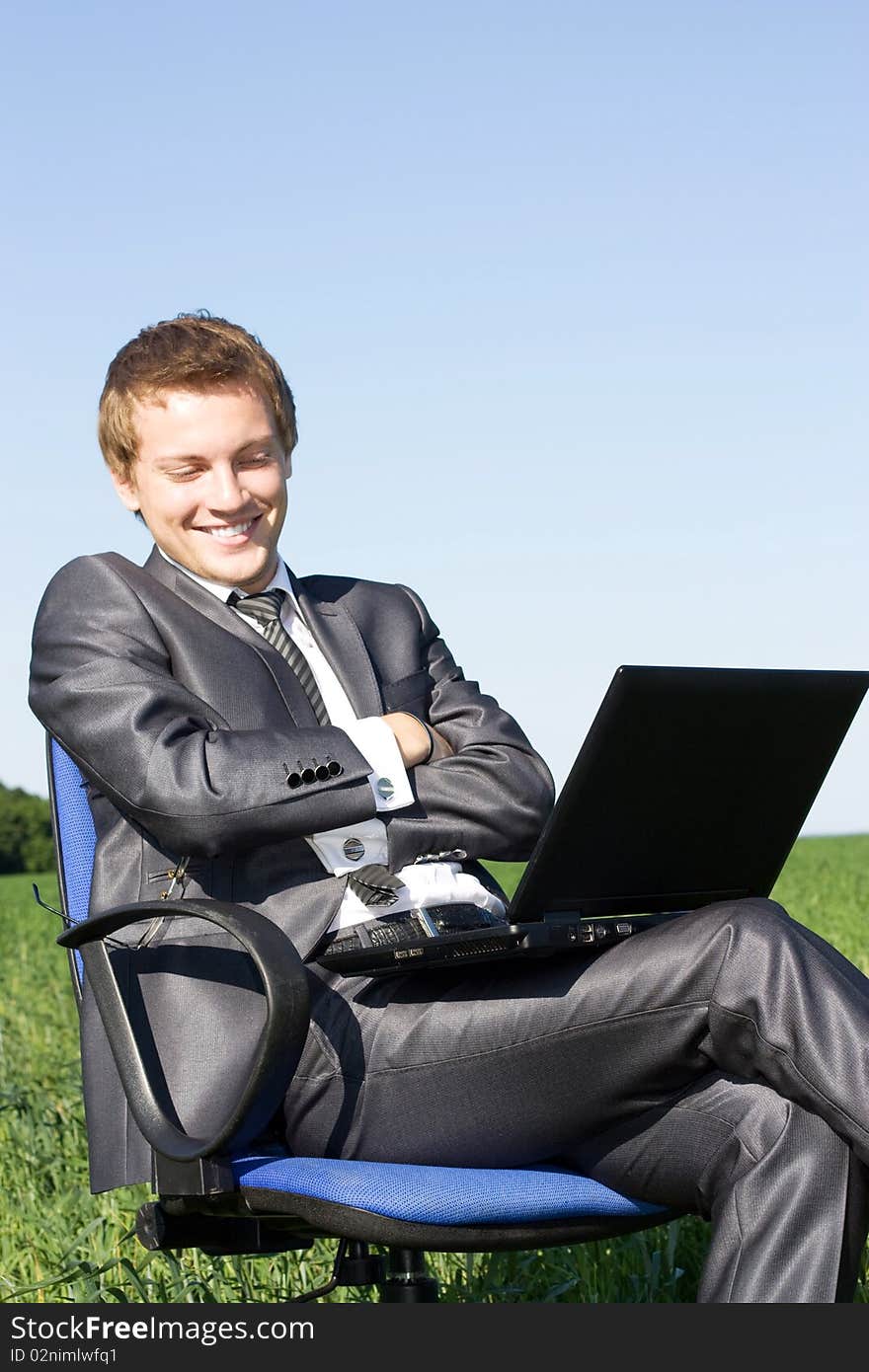 Successful Businessman On Street With A Laptop