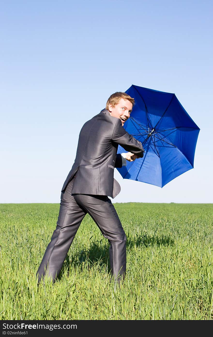 Business man with an open umbrella.Protection