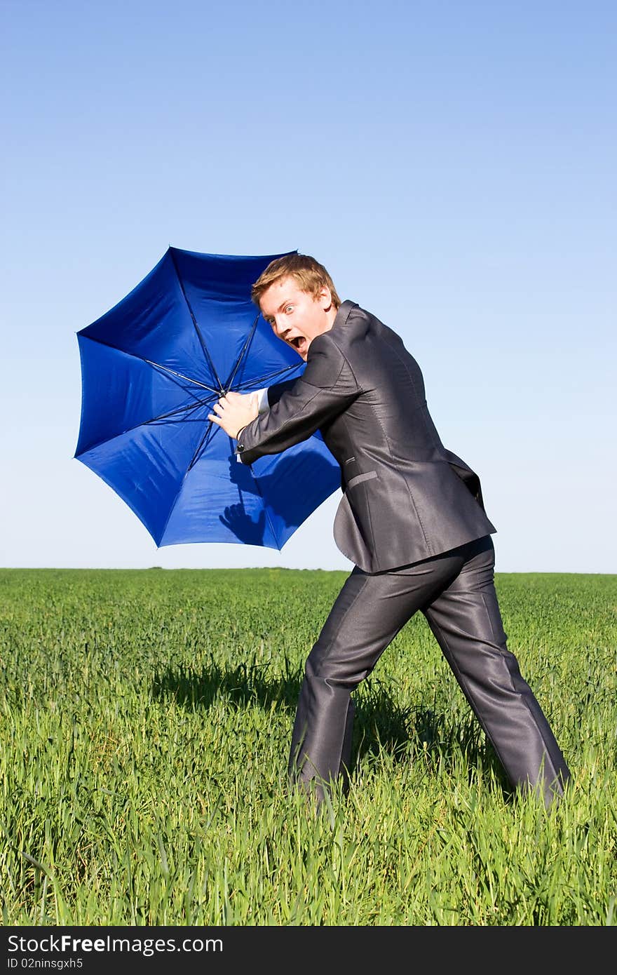 Businessman finding protection in field