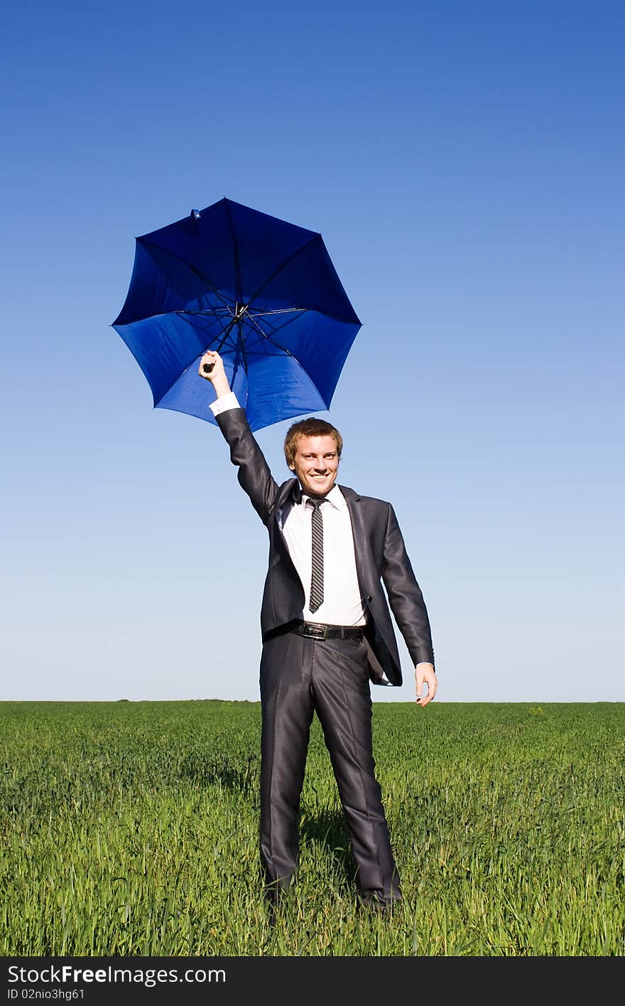 Conceptual photo of businessman flying on umbrella