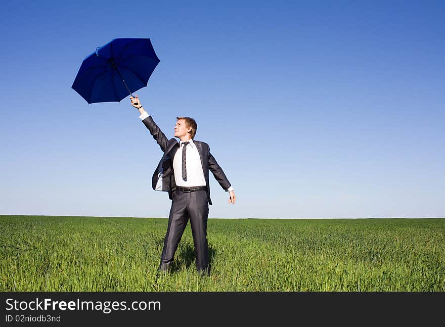 Portrait of businessman under umbrella on the sky