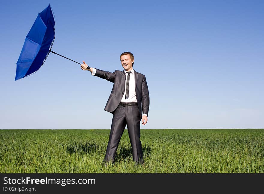 Businessman In The Field Carries A Strong Wind