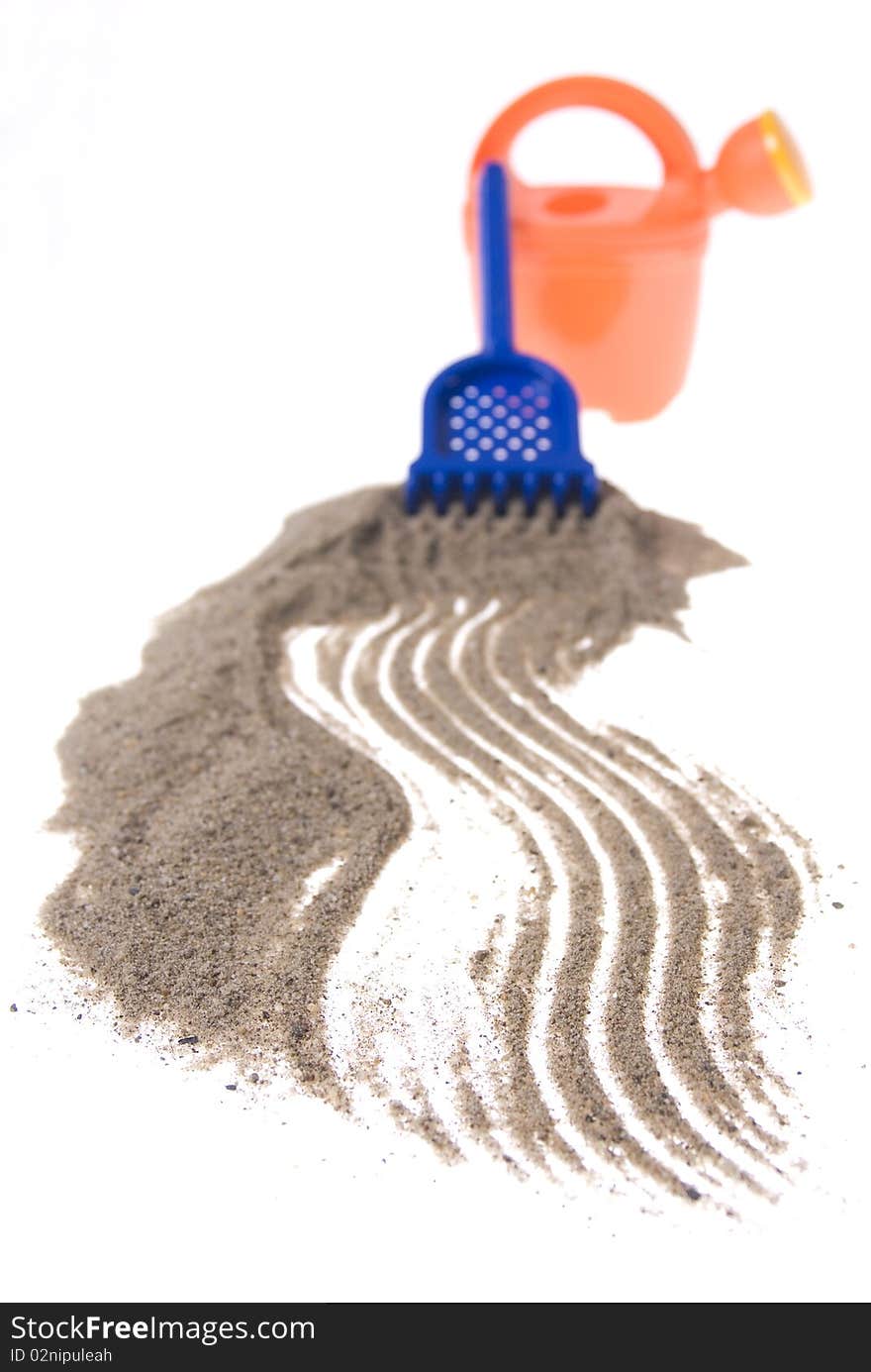 Sand play set - bucket, rack and a pile of sand, on a white background. Sand play set - bucket, rack and a pile of sand, on a white background