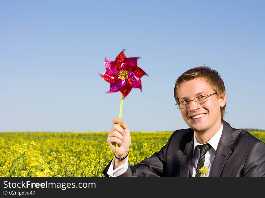 Businessman relaxing in green field