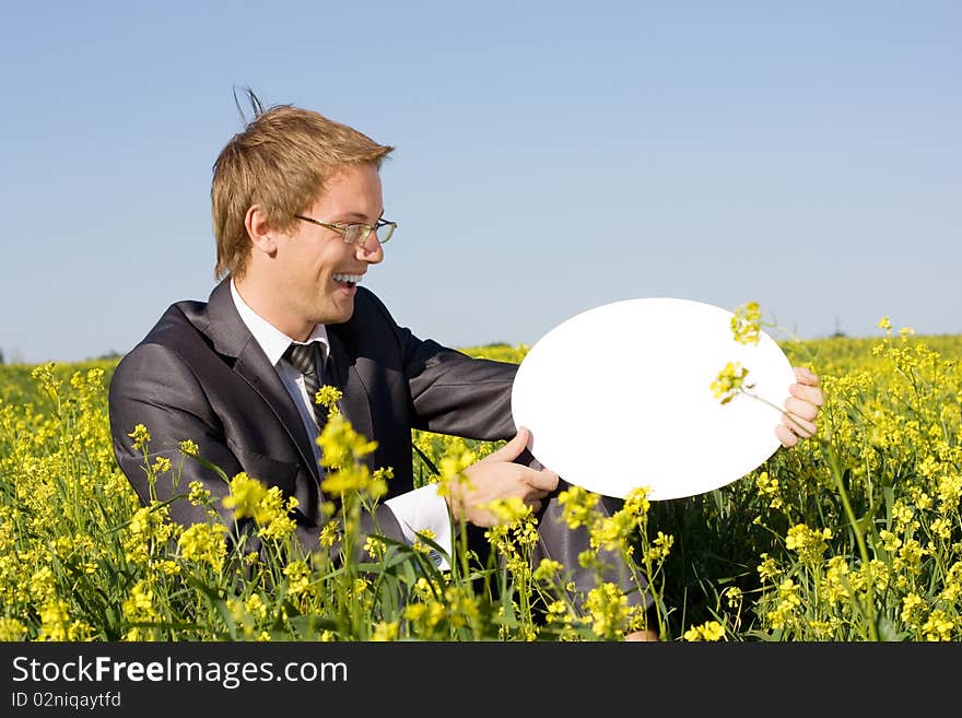 Young businessman in a yellow box holds form