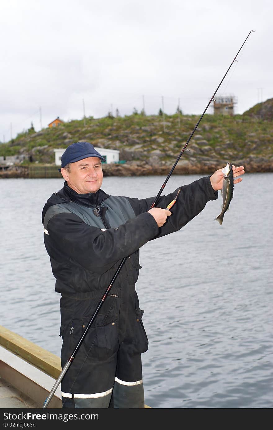 The fisherman on the pier on island Skrova