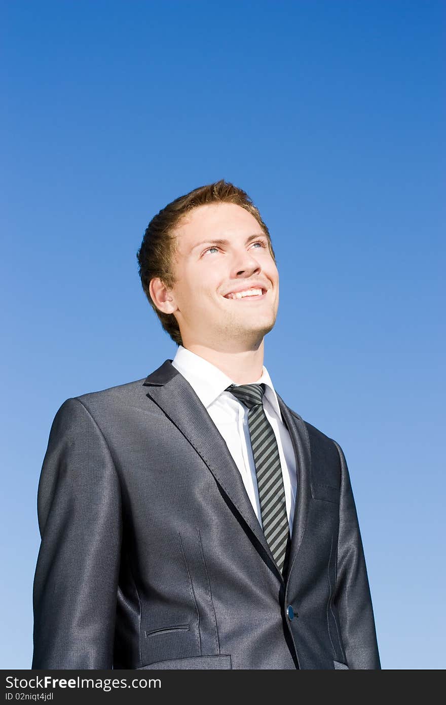 Successful businessman in a suit against the blue sky. Successful businessman in a suit against the blue sky