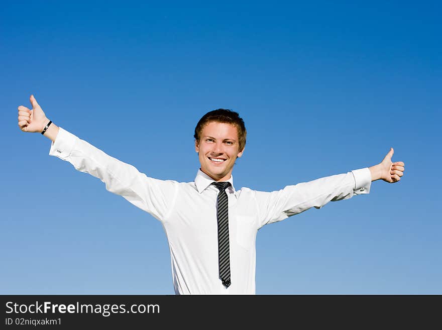 Portrait of happy businessman lifting up hands