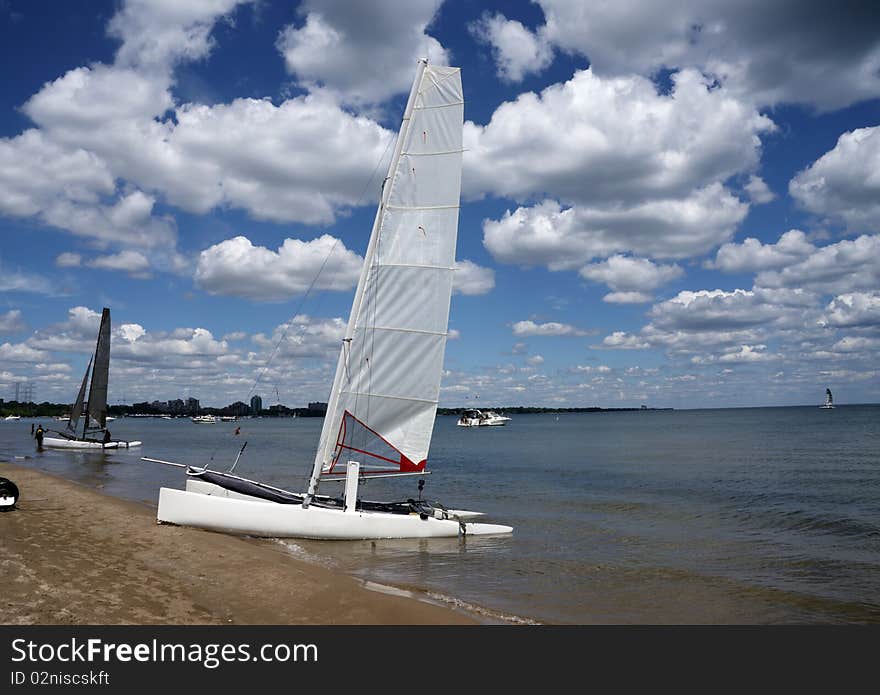 Boat in a lake ready to sail with blue sky and white clouds