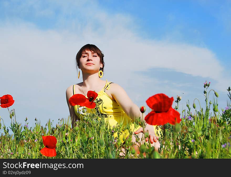 Beautiful girl sitting in the grass