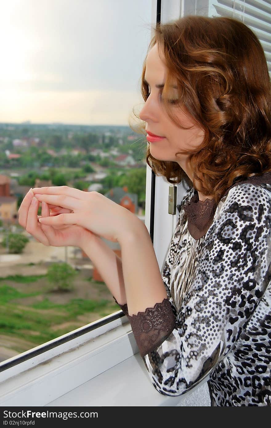 Melancholy woman by the window